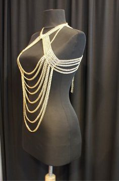 Here's a great and totally unique body chain necklace that makes the old 'little black dress' take on a whole different meaning! This gold body chain as I like to call it, adds the perfect amount of deco to your once all too simple party dress. It also looks great worn over a loose shirt, with jeans, conforming to the body in all the right places. Its great for a cocktail party or a night out at the clubs, this is definitely an attention grabbing piece. Would you like to see more body chain jewe Festival Clavicle Chain Necklace, Gold Bohemian Body Chain For Festivals, Bohemian Gold Body Chain For Festivals, Gold Adjustable Body Chain For Festivals, Gold Body Chain With Adjustable Chain For Festivals, Gold Body Jewelry With Adjustable Chain For Festivals, Gold Festival Body Jewelry With Chain, Gold Body Jewelry With Chain For Festival, Gold Metal Body Chain For Festival