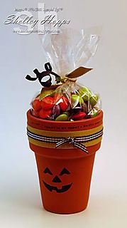 an orange pot filled with candy and candies