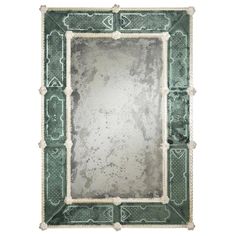 an old green and white mirror on a white background