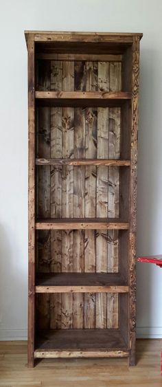 an old wooden bookcase sitting on top of a hard wood floor