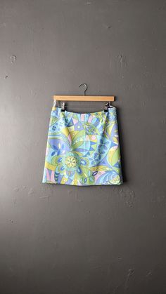 Classic 60s a-line skirt, very influenced by psychedelic culture. Lightweight and ideal for summer! Bellmans Crimplene Labelled a 28 waist, this best fits a UK size 10 ( Bust=35 inches (88 cm) Waist=27 inches (68 cm) Hips=36 inches (93 cm) Garment Measurements: Waistband= 28 to 32 inches (71 to 81 cm) Hips= 36 inches (91 cm) Length= 17 1/2 inches (44 cm) In great vintage condition- the original elastic in the waistband had perished, but I have replaced it. Retro Green A-line Skirt, Retro Blue Fitted Skort, Retro Spring Flared Mini Skirt, Retro Flared Mini Skirt For Spring, Retro Blue Skort For Spring, Retro Flared Mini Skirt For Summer, Spring Retro Blue Skort, Vintage Retro Print Skirt For Spring, Vintage Skirt With Retro Print For Spring