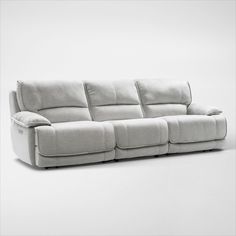 a white couch sitting on top of a white floor