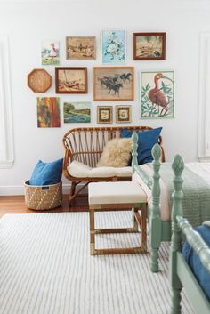 a living room filled with lots of pictures on the wall above a chair and ottoman