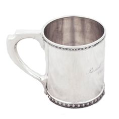 a silver mug with diamond trimmings on it