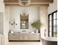 a large bathroom with two sinks and a bathtub in the center, along with a chandelier