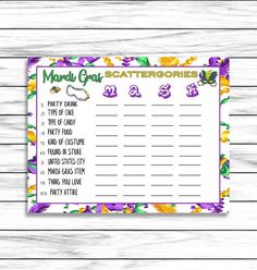 the mardi gras printable game is shown on a white wooden background with purple flowers