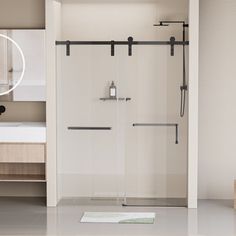 a bathroom with a shower, sink and mirror