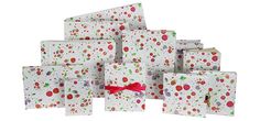 a pile of white boxes with red bows and polka dots on them, all stacked together