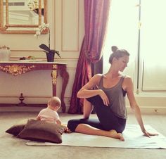 two women doing yoga in front of a window and another woman sitting on the floor