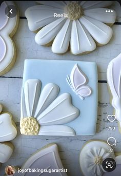 some cookies are decorated with white icing and flower decorations on them, along with other cookie decorating supplies