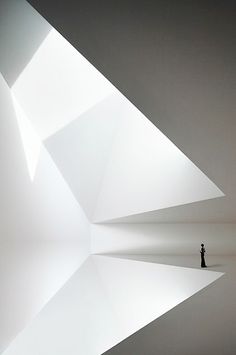 a person is standing in the middle of a room with white walls and flooring