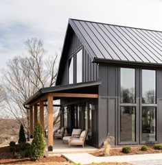 a house with a metal roof and glass windows