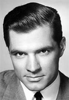 an old black and white photo of a man in a suit with a serious look on his face