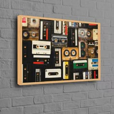 a wall mounted on the side of a brick building with cassette tapes and tape recorders all over it