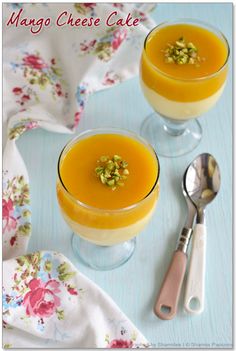 two glasses filled with orange juice and topped with pistachio