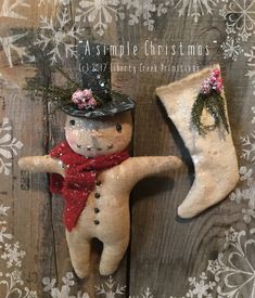 a snowman and stocking hanging on a wooden wall