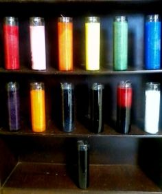 a shelf filled with lots of different colored candles