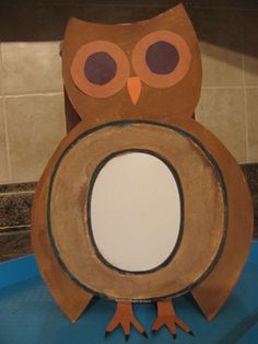 an owl sitting on top of a toilet seat