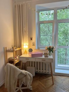 a room with a desk, chair and window