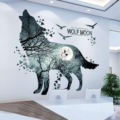 a wolf wall mural in an office with birds flying over it and the words wolf moon