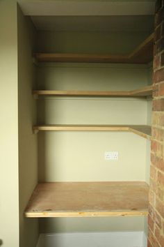 an empty closet with some shelves in it