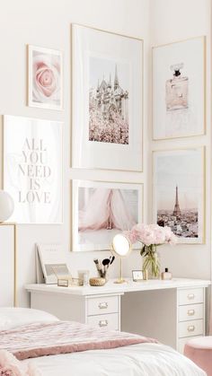 a white bedroom with pictures on the wall