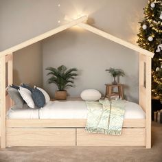 a bedroom with a bed and christmas tree in the corner next to it on carpeted flooring