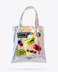 a clear shopping bag with stickers on the front and side, sitting against a white background