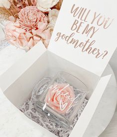 a pink rose in a white box that says do you really be my godmother?