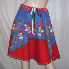 a mannequin wearing a skirt with gnomes on it and red trimming