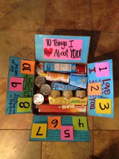 an open box filled with lots of different items on top of a tile floor next to a sign that says 10 things i about you