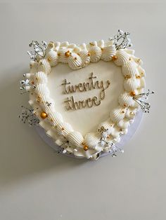 there is a heart shaped cake with writing on it that says, twenty threes