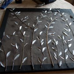 a table topped with metal branches and leaves