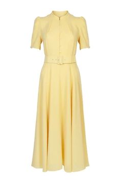 The ahana dress in lemon yellow is a classic, wardrobe must-have. crafted from a beautiful lemon wool crepe, this dress has a full skirt and tailored bodice. the ahana is an elegant choice for any season, and produced in a rws certified100% wool crepe with a fit and flare silhouette. the short stand neckline has been updated and the elegant sweeping skirt is belted at the waist for a figure-defining fit. we love the charming button front detail. Beulah London, Floral Evening Dresses, Flare Dresses, Wool Crepe, London Dress, Silk Shift Dress, Chiffon Midi Dress, Lemon Dress, Fashionista Clothes