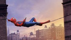 spider - man flying through the air over a city