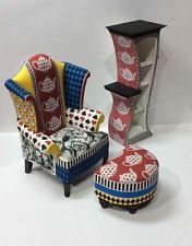 three chairs and two stools made out of paper with designs on them, sitting next to each other