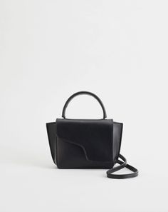 Everyday is the montalcino's middle name. she fits all your essentials plus an afternoon snack. she can be worn both on your arm or cross-body as desired.    material    vegetable tanned leather    color    black    size    h 4.3in w 7in d 2.3in    crossbody strap drop: 20.9in    origin    handmade in italy Atp Atelier, Women's Bags By Style, Mini Handbag, Handbags Affordable, Classic Bags, Black Leather Handbags, Mini Handbags, Branded Handbags, Cute Bags