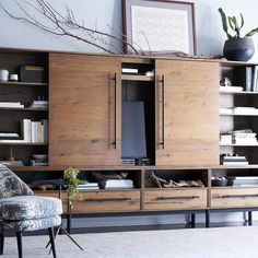 a living room filled with furniture and bookshelves next to a wall mounted tv