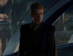 a young man in a star wars outfit standing next to a sci - fi city