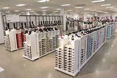 the inside of a shoe store with lots of shoes on display