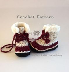 a pair of crocheted baby boots with bows on the front and bottom, made to look like snow boots