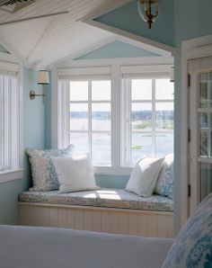 a window seat with pillows on it in a bedroom