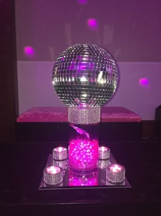 a table topped with candles and a disco ball