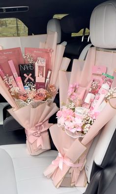 pink flowers in the back seat of a car with personal care items wrapped around them