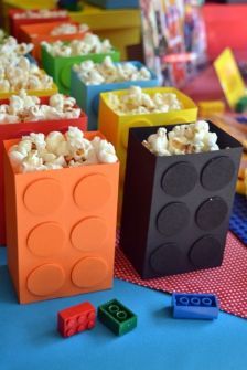 some legos are sitting on a table with popcorn