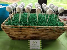 a basket filled with cake pops sitting on top of a table