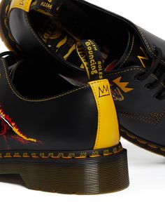 Exploding into the New York art scene in the early 80s, Jean-Michel Basquiat’s legacy and presence is still alive today. Our 1461 shoe has been printed with ‘Pez Dispenser’ (1984), which sees the world-renowned, radical dinosaur painting printed across both the Smooth leather upper and sock liner. Detailed with a yellow Smooth leather backstrap with Basquiat crown detailing. Finished with our iconic black and yellow scripted heel loop, sole pad print and a standout lace jewel. And arrives in bes Basquiat Crown, Dinosaur Painting, Fred Perry Shirt, Michel Basquiat, Early 60s, Jean Michel Basquiat, Leather Oxford Shoes, New York Art, Jean Michel