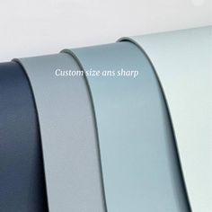 three different color belts hanging on a wall with the words custom size and shape above them