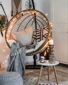 a living room filled with lots of furniture and lights on the wall next to a round chair