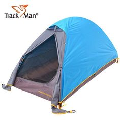 a blue and gray tent sitting on top of a white floor with the words track man written